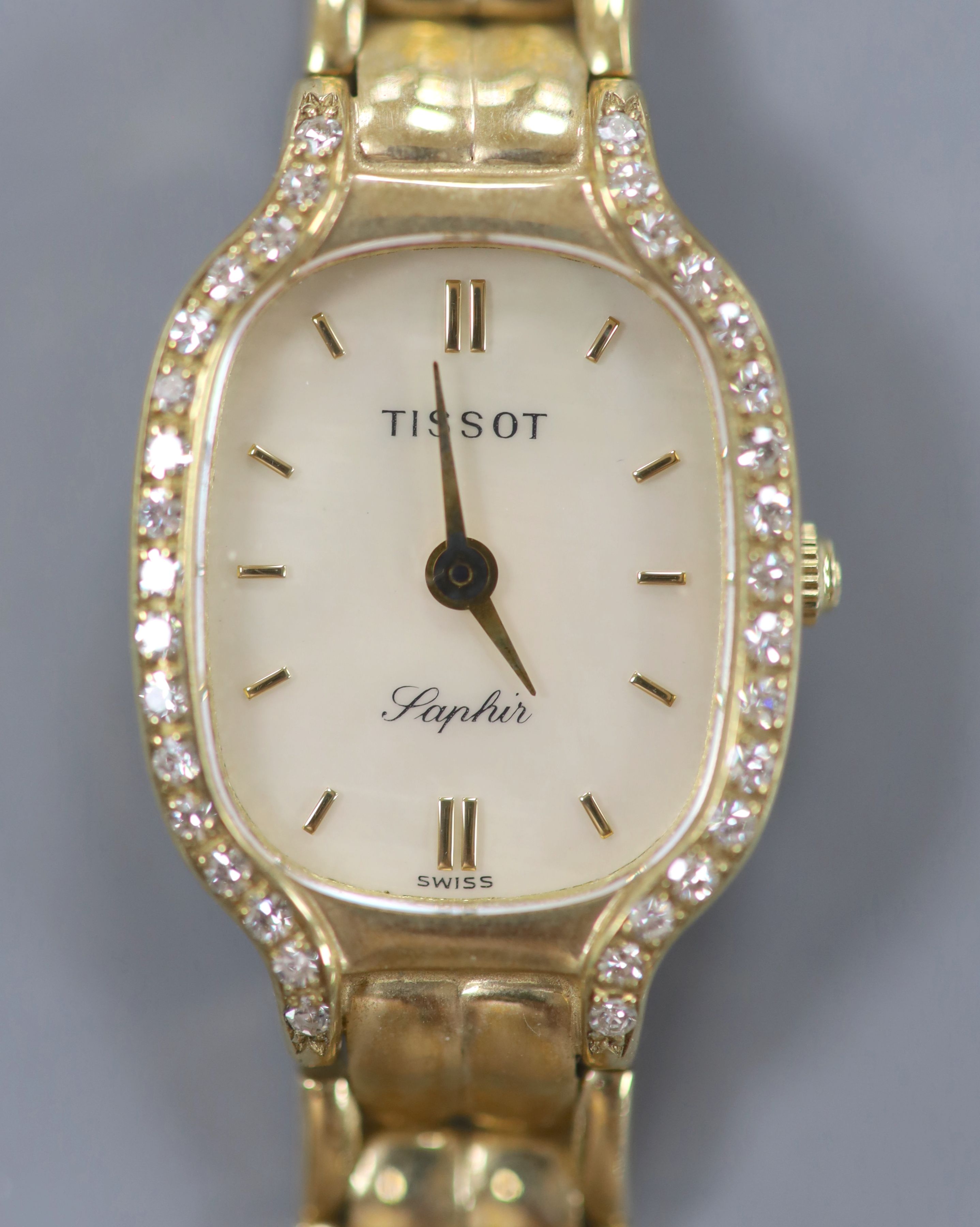 A lady's modern 9ct gold and diamond set Tissot Saphir quartz? wrist watch, 18.5cm